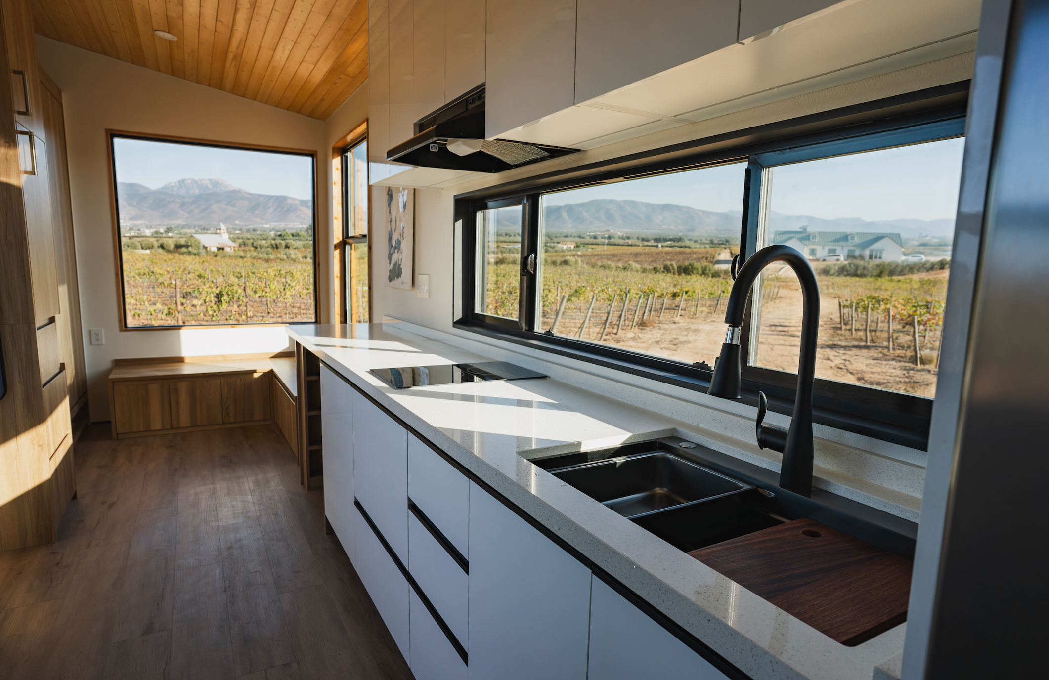 Modern tiny home featuring large windows. 