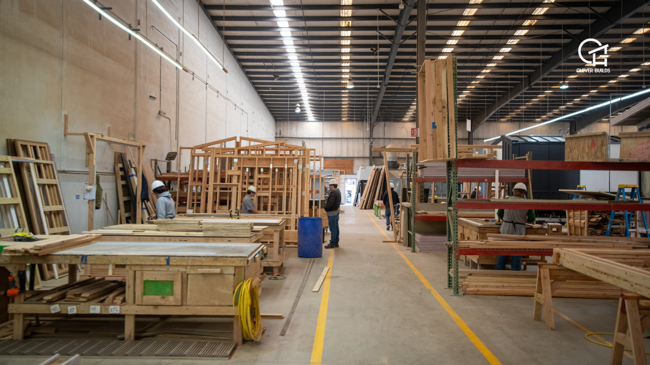 Skilled builders working on a tiny home inside the state-of-the-art Clever Tiny Homes factory