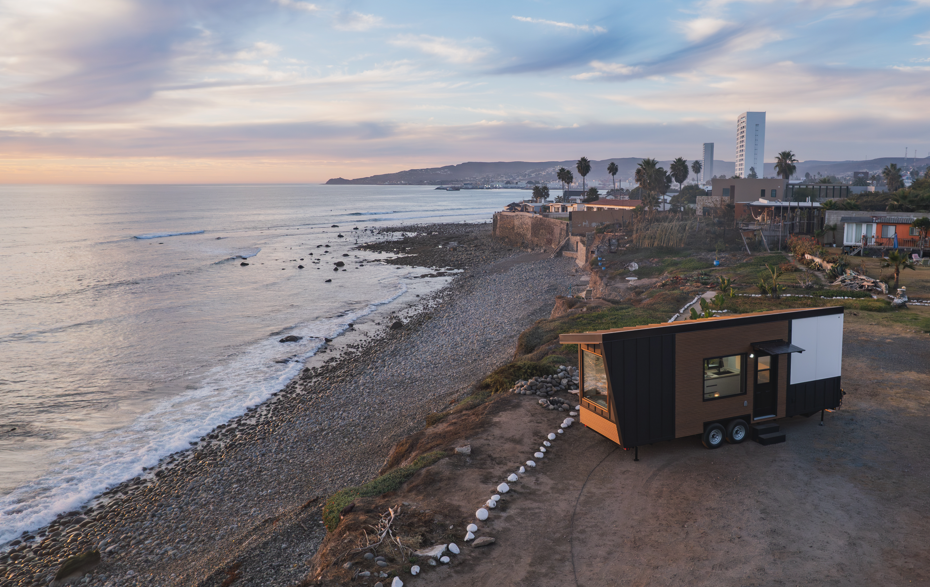 Clever Tiny Home parked near the beach, engineered rainscreen wall detail shown to handle salty air and ocean moisture
