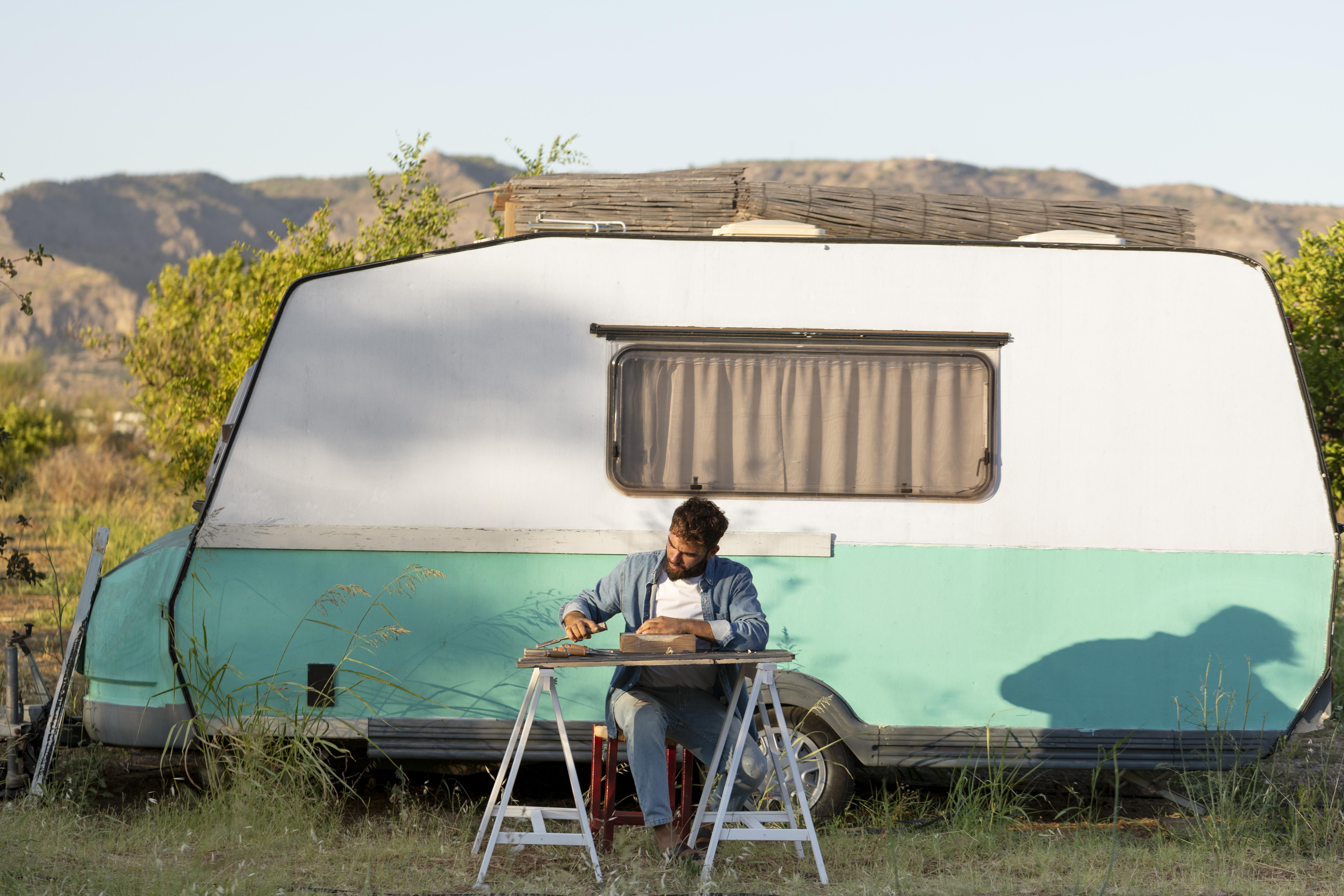A man in front of his RV enjoying the outdoors