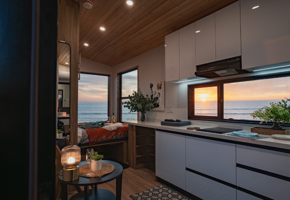 Interior of Clever S tiny home with Murphy bed in use, maximizing space in the living area.