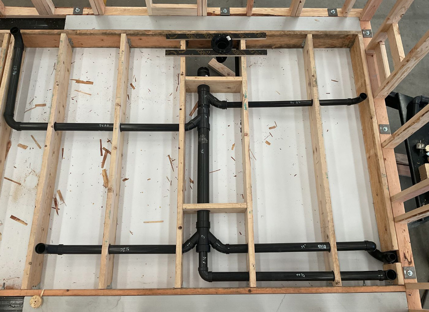 Photo of a wall template used at Clever Tiny Homes with precise cutouts and guides for framing, designed to streamline the construction process.