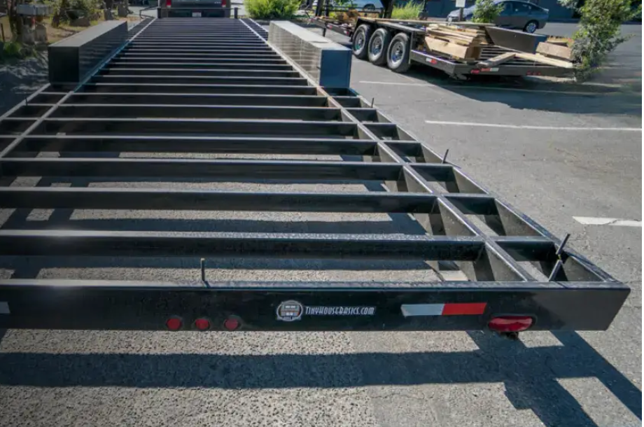A close-up view of a tiny home trailer chassis