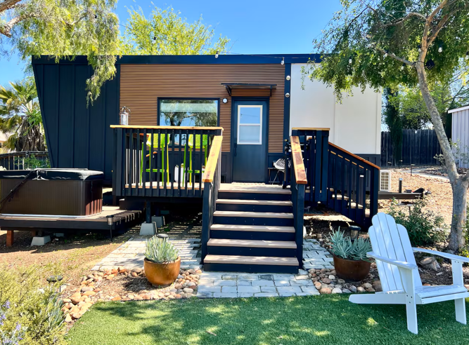 Photo: Clever home with centered stairs, railings, hot tub, and styled landscaping (Airbnb).