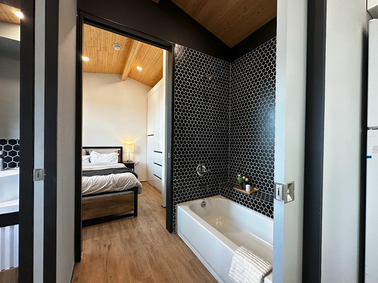 Luxury tiny home bathroom with bathtub, real tiles and large vanity