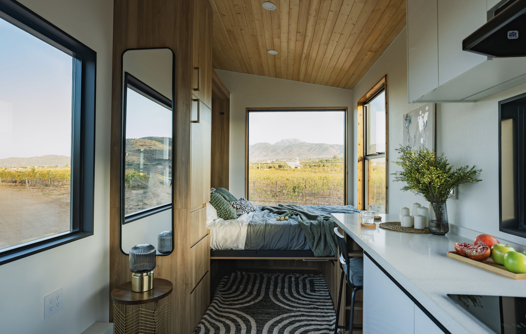 A murphy bed that folds up during the day in a Clever Tiny Home studio.