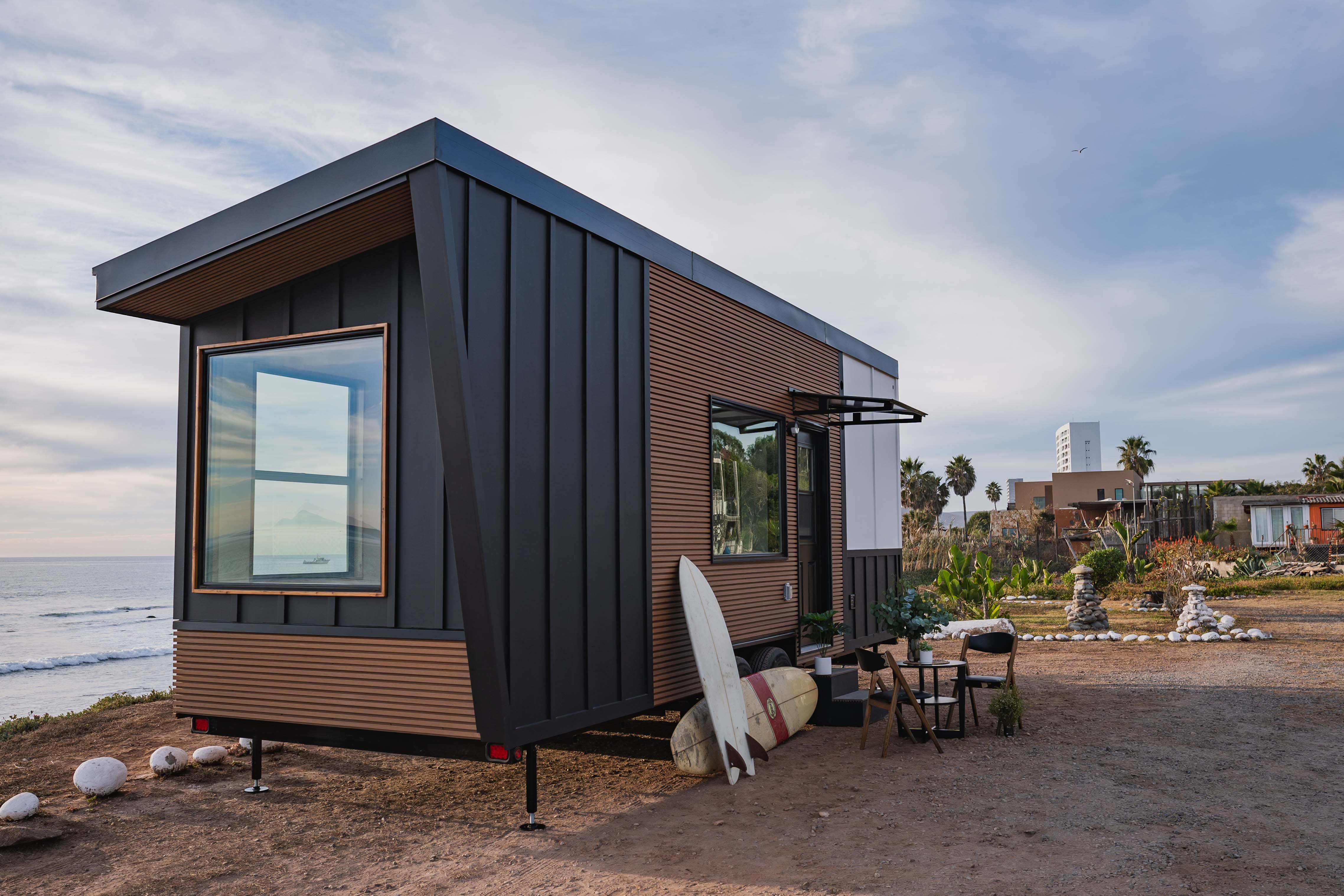 Photo of a tiny house on wheels parked at a beach