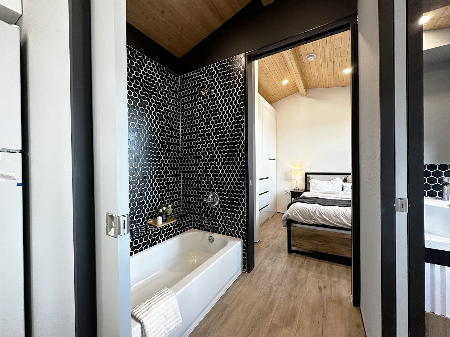 Interior of a modern tiny home with a bedroom downstairs