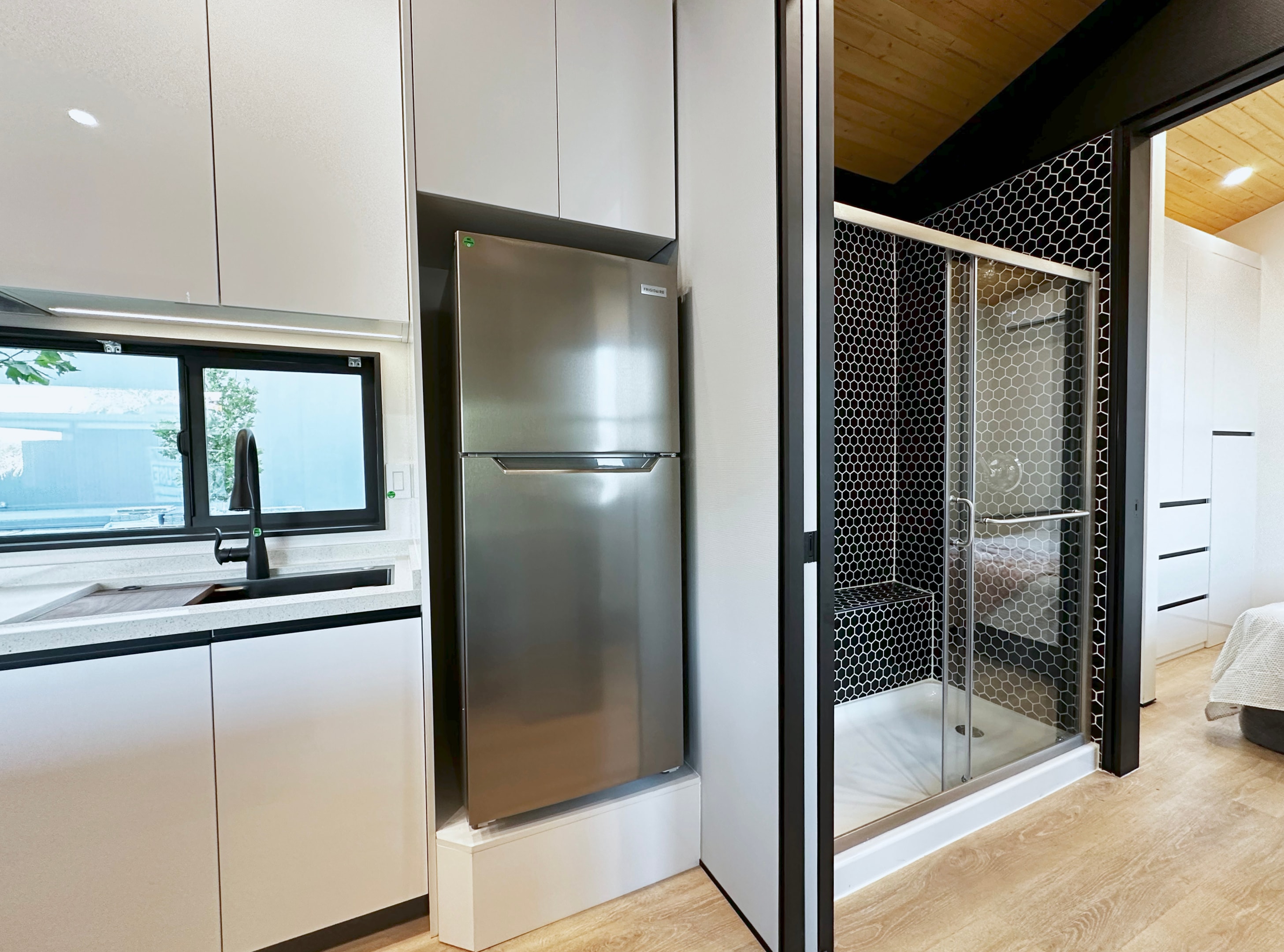 Real tiles line the walk-in shower of a modern tiny home.