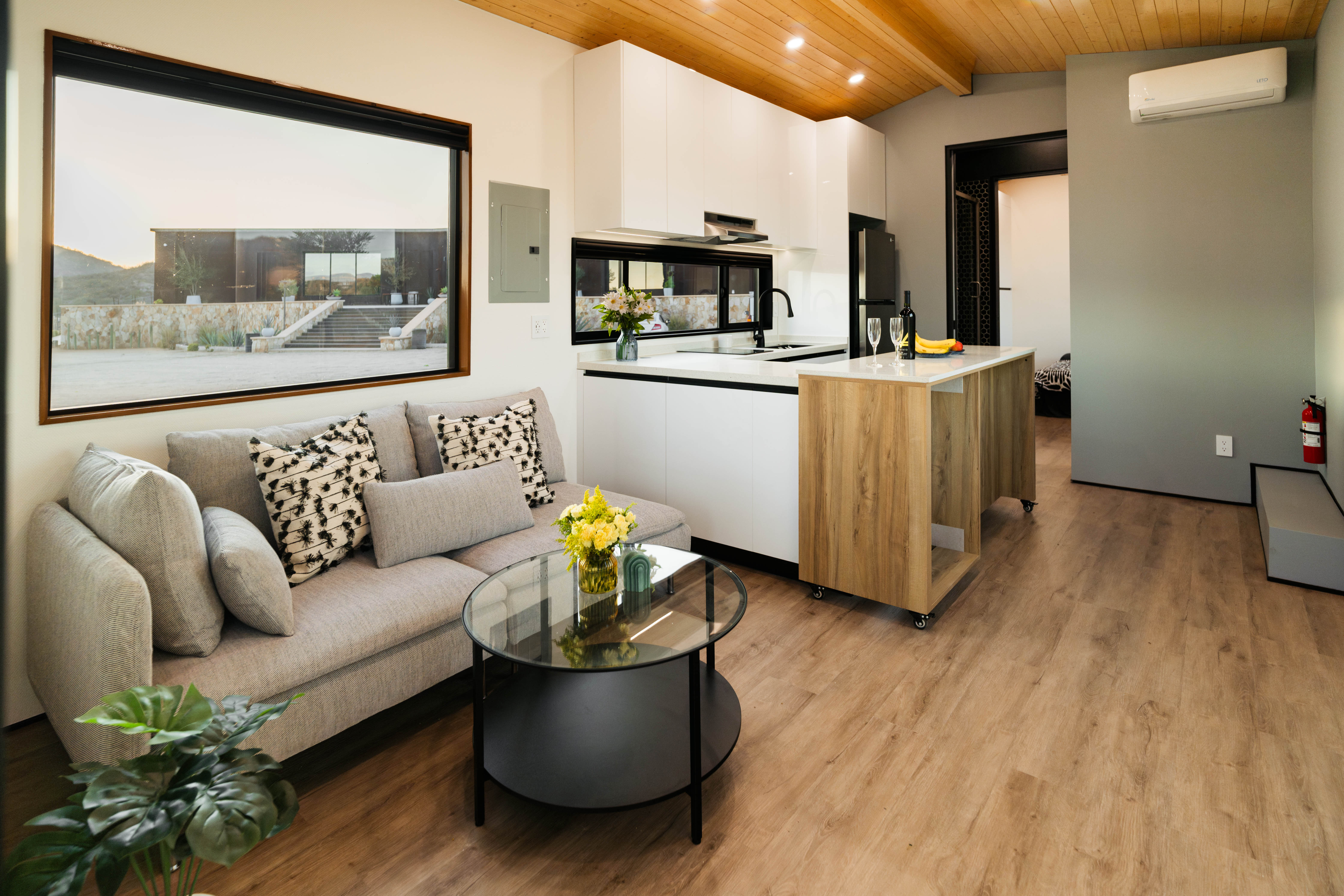 “Interior of a modern tiny home showing smart storage and efficient layout for livability in a small footprint.