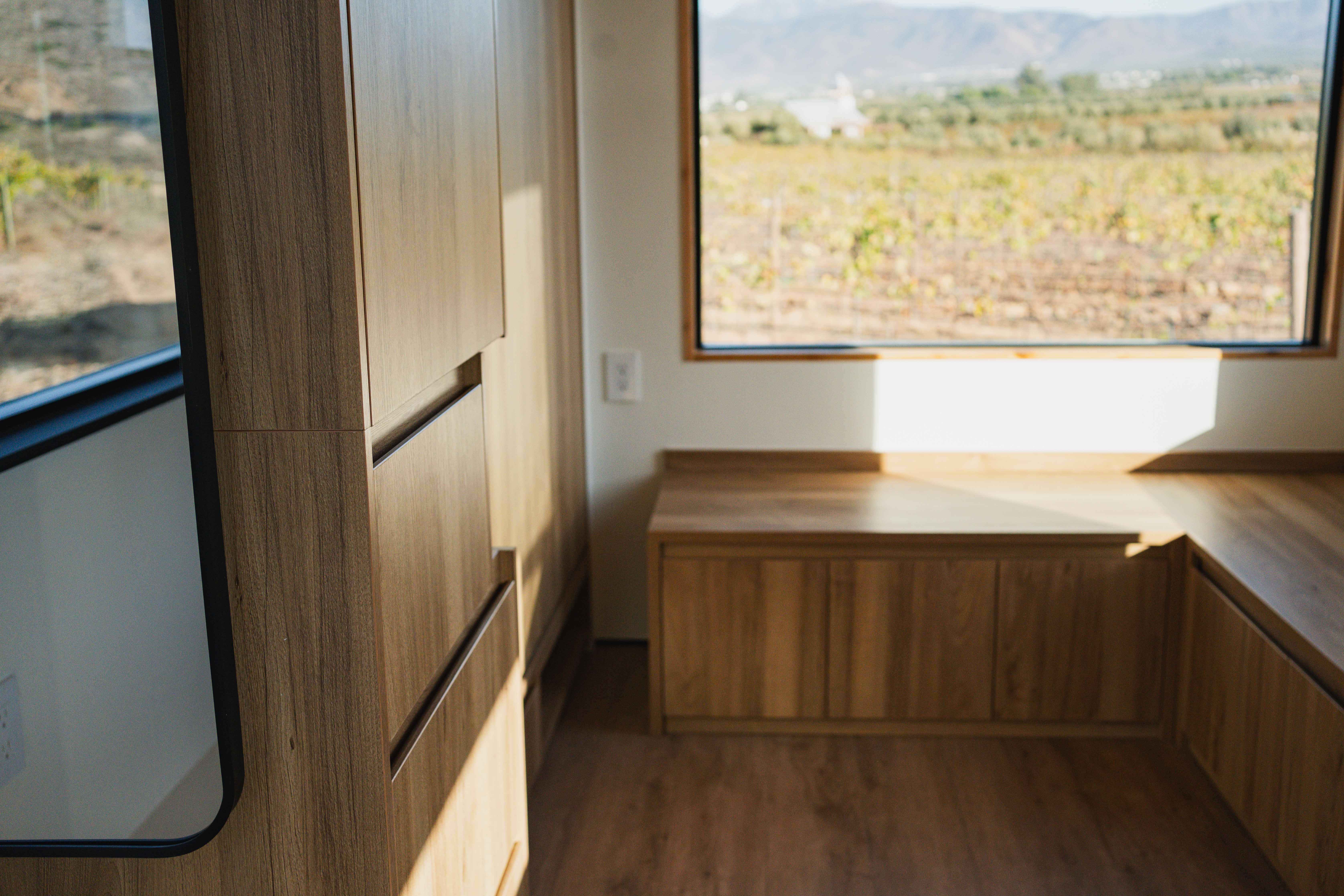 Bench that doubles a storage in a Clever Tiny Home studio.