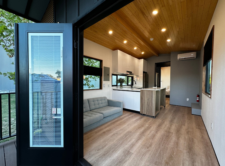 View from entry door into Clever 1 tiny home kitchen with open-plan layout and airy design.