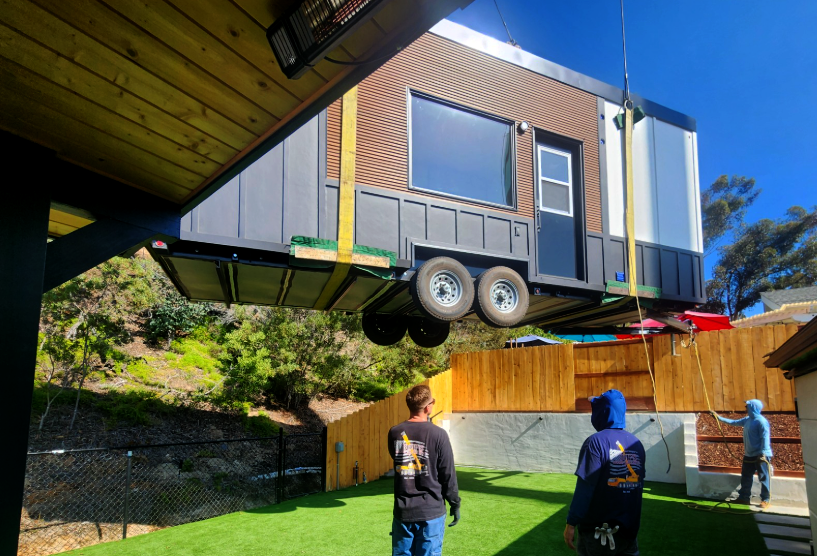 Clever S tiny home on wheels being craned into place during delivery