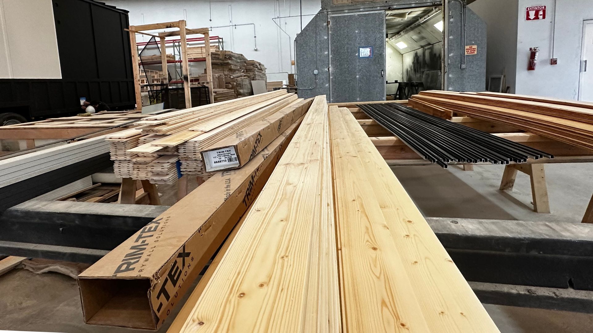 Wood framing materials bought in bulk inside a modern tiny home factory.