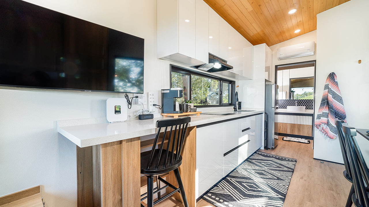 A studio tiny home from Clever shows an open floor plan with high-end, luxurious finishes